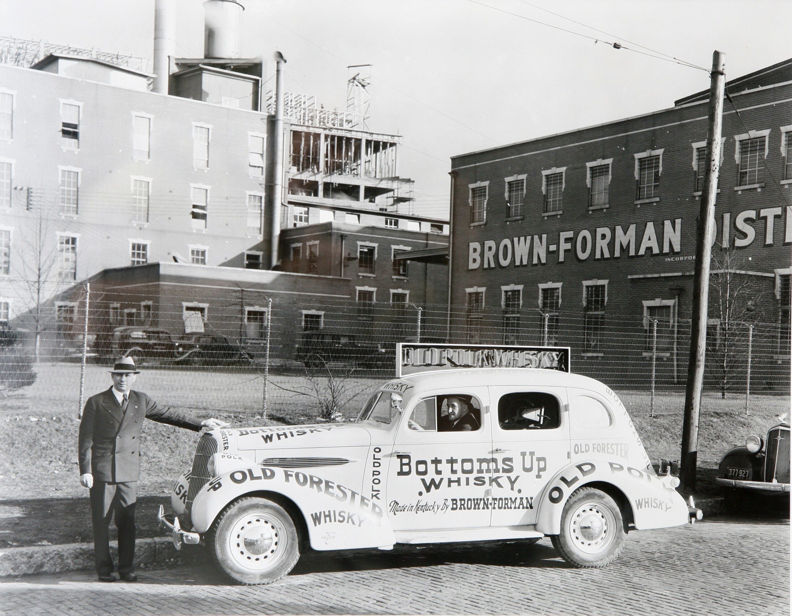 Photo of man with car outside of the Brown Forman factory