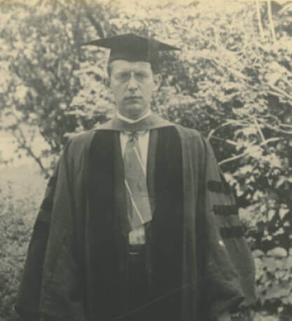 Young man in collegiate cap and gown.