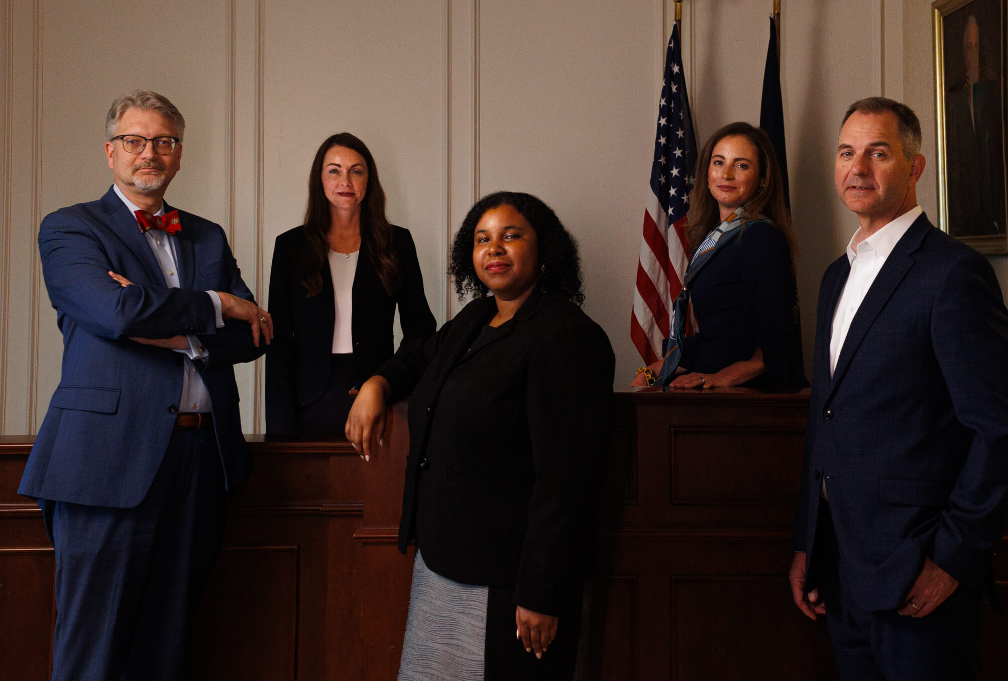 Five attorneys in a room, posing for a photograph.