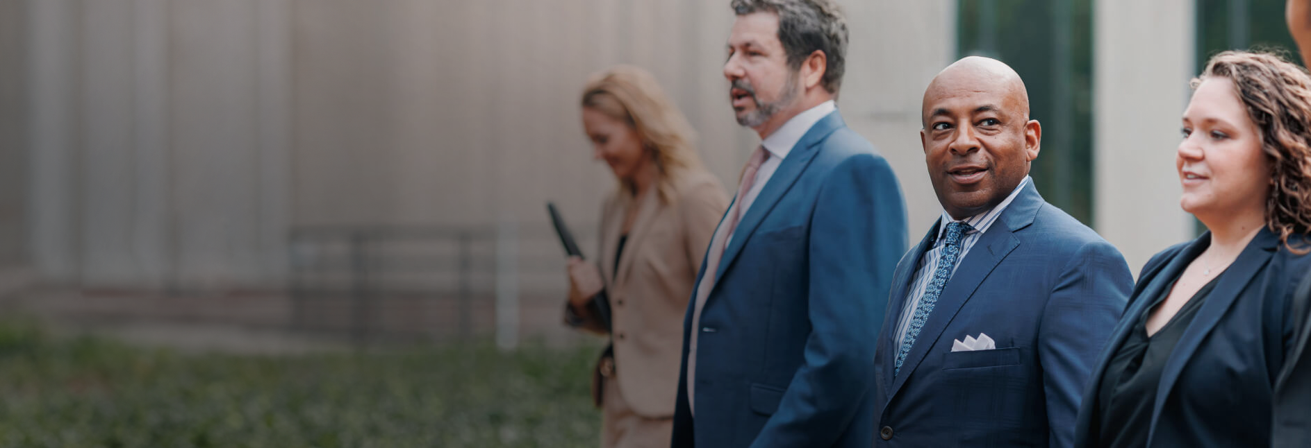 sko-law-firm-employees walking on sidewalk near business building