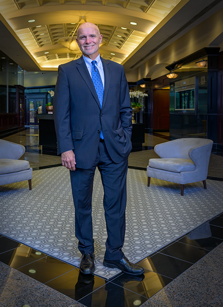 Managing Director, P. Douglas Barr standing in office building.