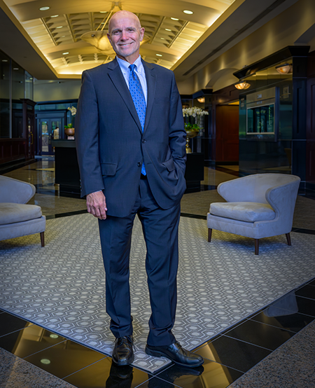 Managing Director, P. Douglas Barr standing in office building.